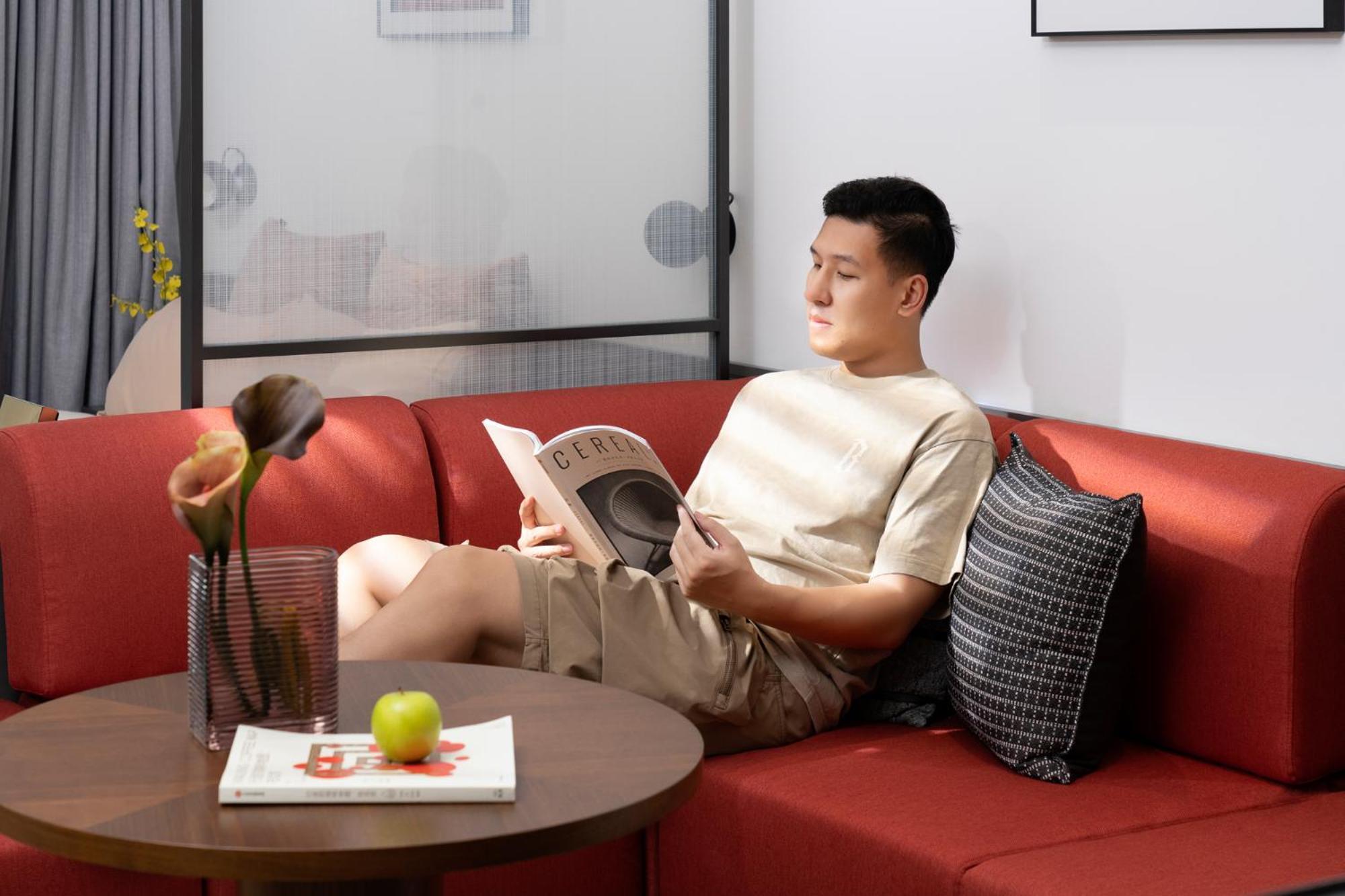 Base-Beijing Wangfujing Serviced Apartment- In Hutong &Bike Rental &Close To Forbidden City, Tian'Anmen Square &Subway Nearby &Free Coffee &Washing Machine,Kitchen &Restaurant Discount &English Speaking &High Speed Free Wifi Exteriör bild A man reading a book on a sofa